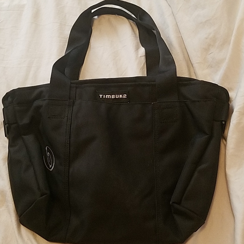 Black Timbuk2 tote bag with zipper at top.